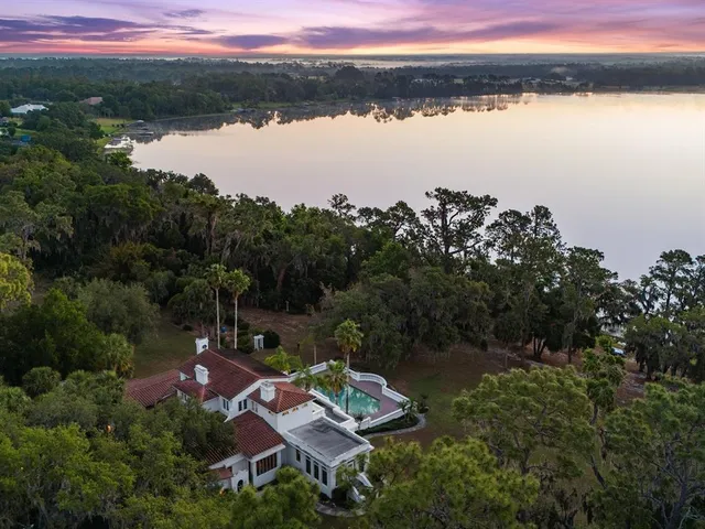 a front view of a house with a garden and plants