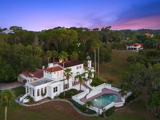 a house with swimming pool in front of it