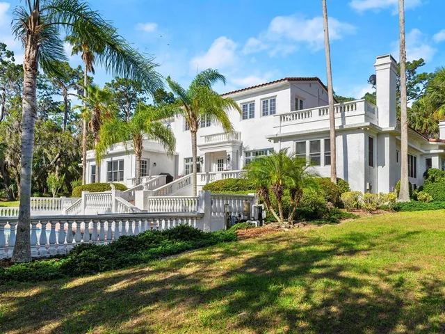 a view of a dining room with furniture a chandelier and wooden floor