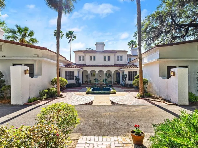 a bedroom with furniture and a large window
