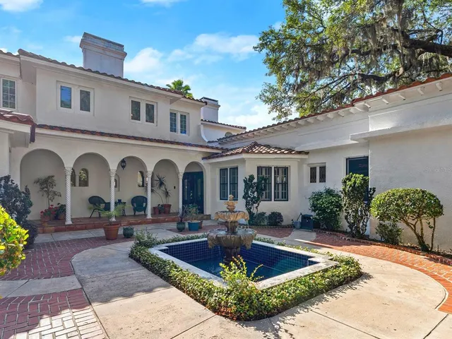 a walk in closet with wooden floor and furniture