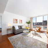 a living room with furniture and a floor to ceiling window