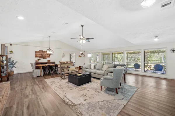 a living room with furniture and wooden floor