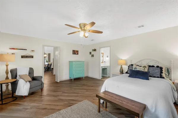 a bedroom with furniture and a chandelier