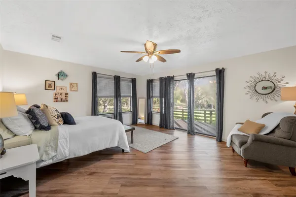 a bedroom with furniture and wooden floor