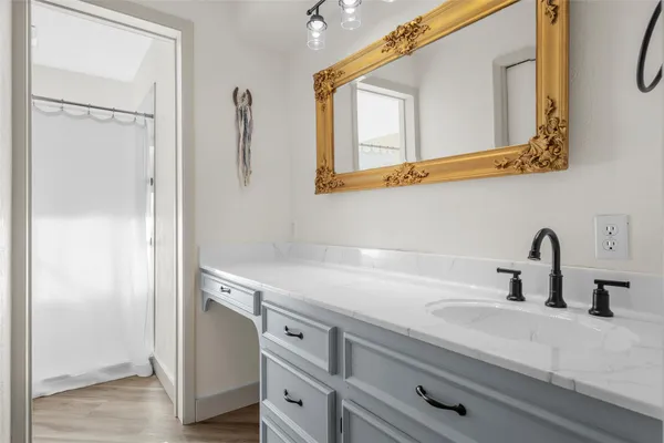 a bathroom with a sink and a mirror