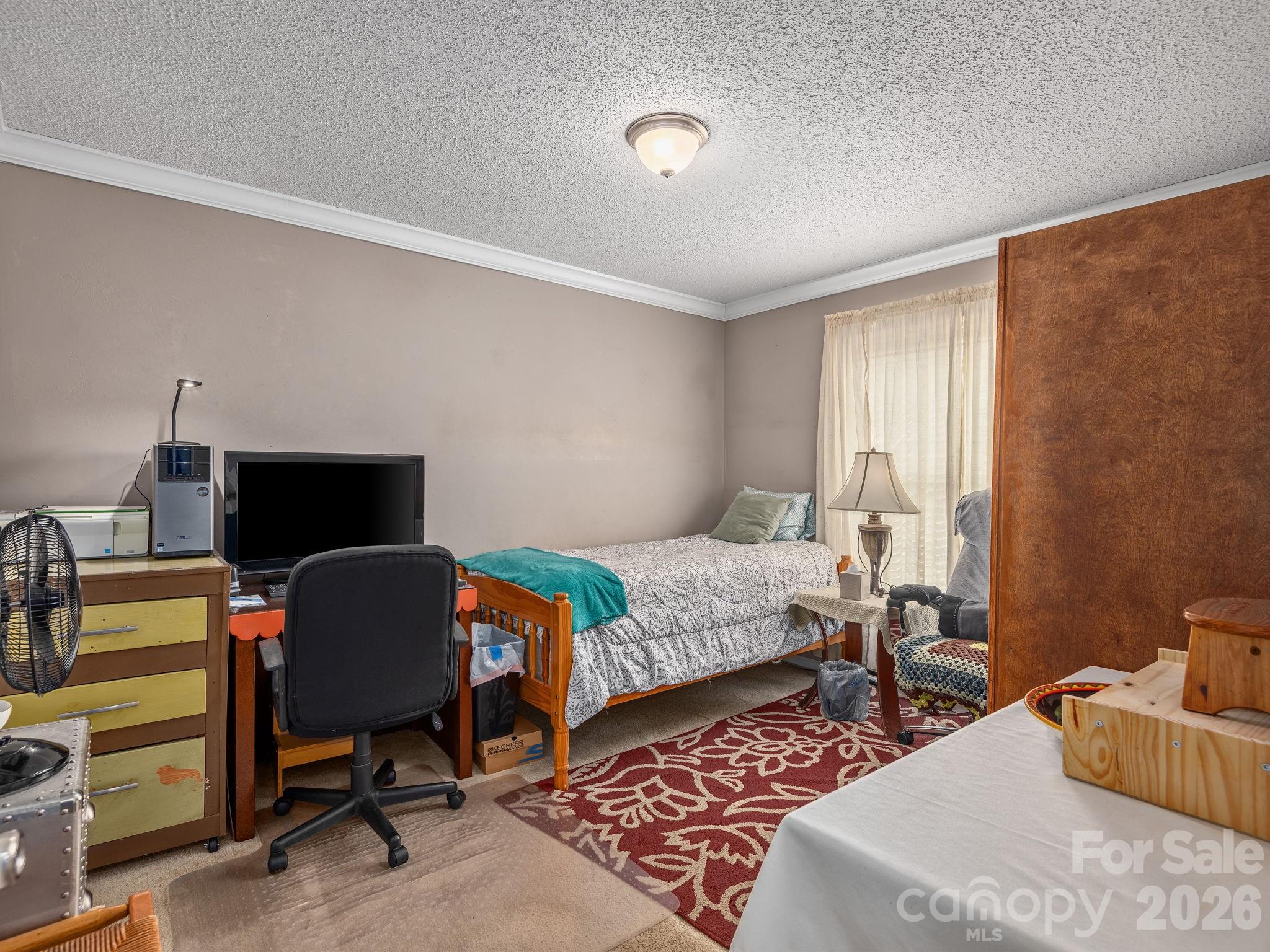 373 Starnes Cove Road Candler, NC 28715 - Photo 14 of 21 a bedroom with bed and a window