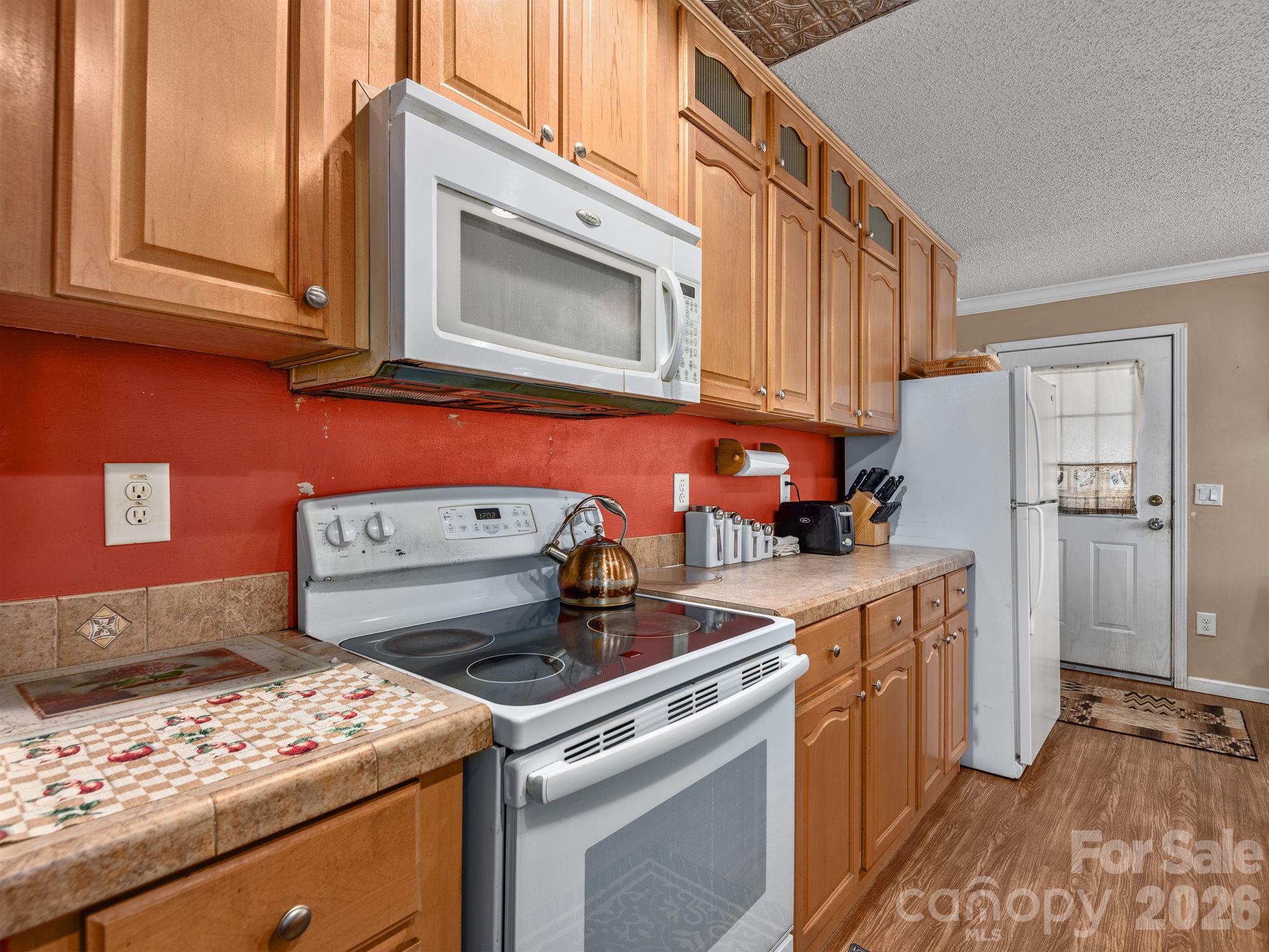 373 Starnes Cove Road Candler, NC 28715 - Photo 5 of 21 a kitchen with a stove and a microwave