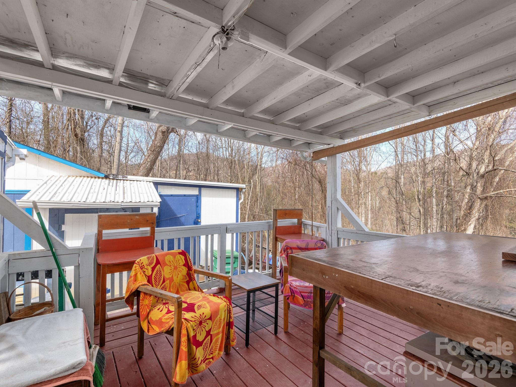 373 Starnes Cove Road Candler, NC 28715 - Photo 7 of 21 a outdoor living room with furniture and a floor to ceiling window