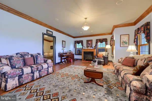 a living room with furniture a couch and a bookshelf