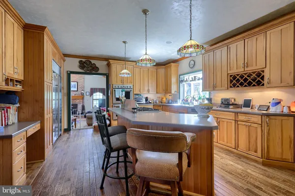 a kitchen with stainless steel appliances granite countertop wooden floors sink and cabinets