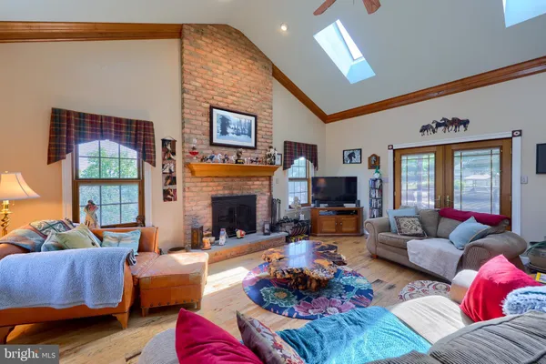 a living room with furniture fireplace and a large window