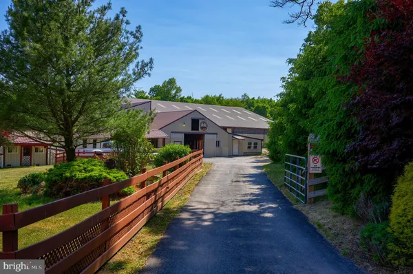 a view of house with garden space and trees