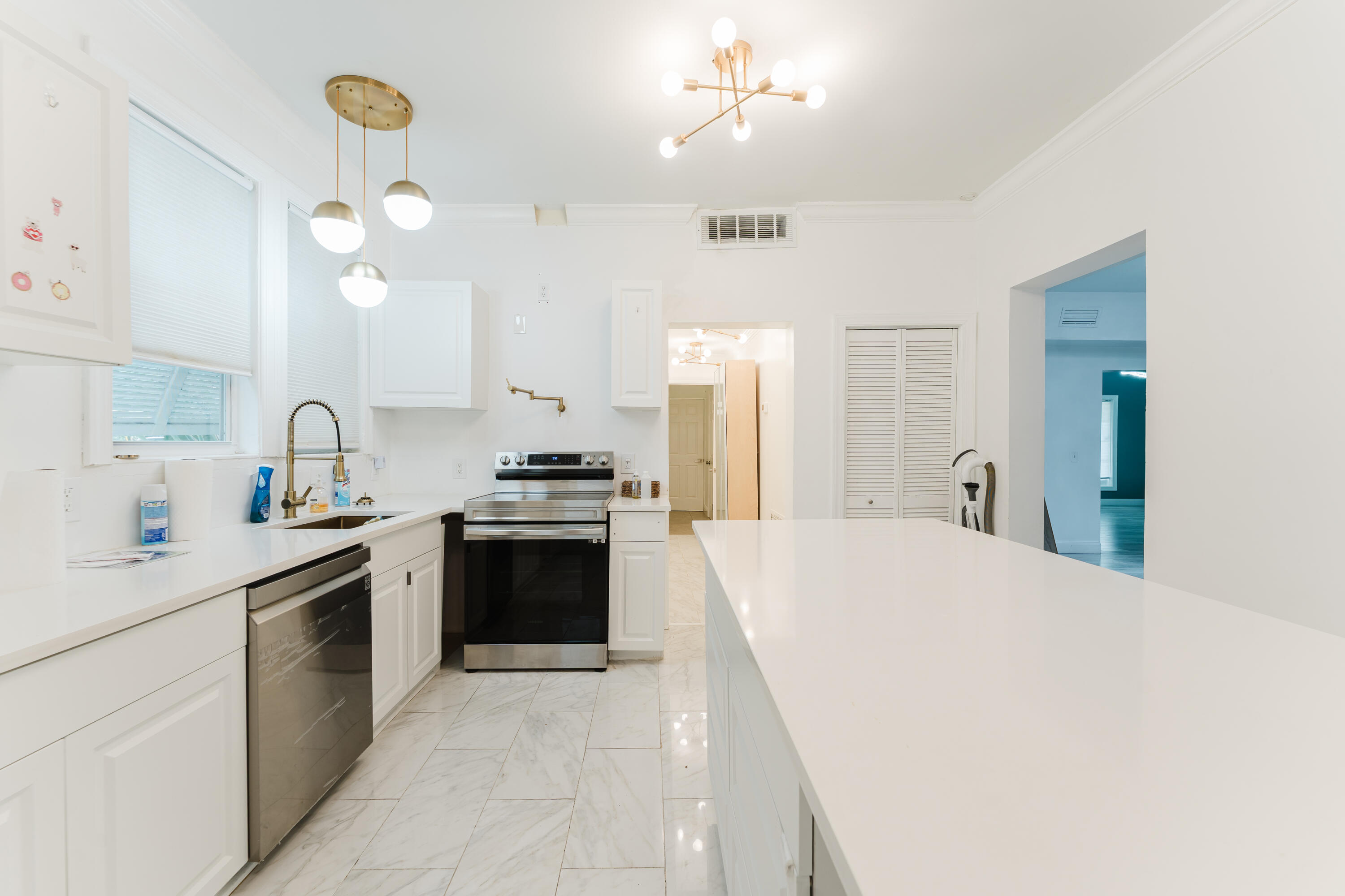 700 East Palmetto Park Road Boca Raton, FL 33432 - Photo 11 of 27 a kitchen with a sink a stove cabinets and wooden floor