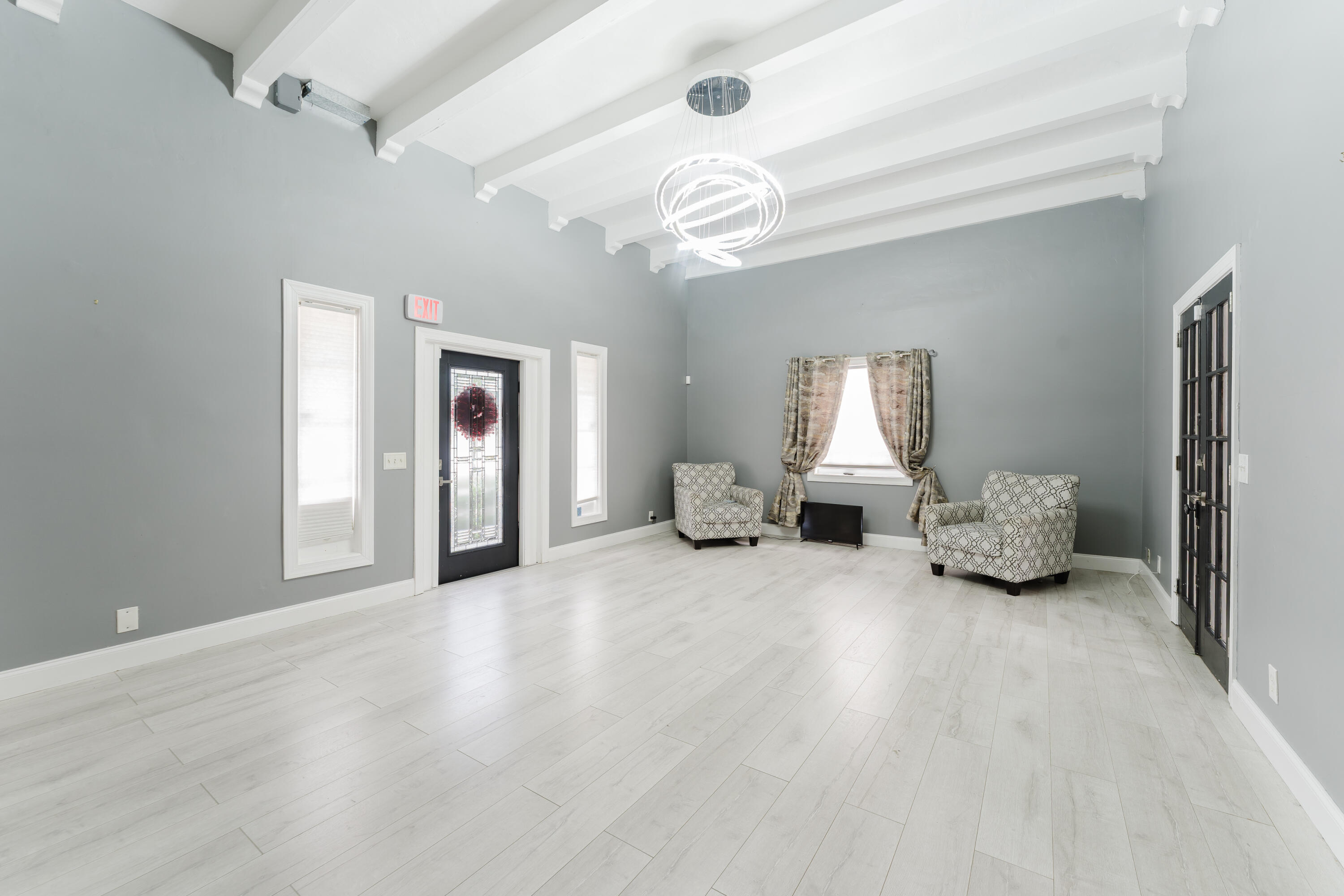 700 East Palmetto Park Road Boca Raton, FL 33432 - Photo 12 of 27 a spacious bedroom with a bed and a chandelier