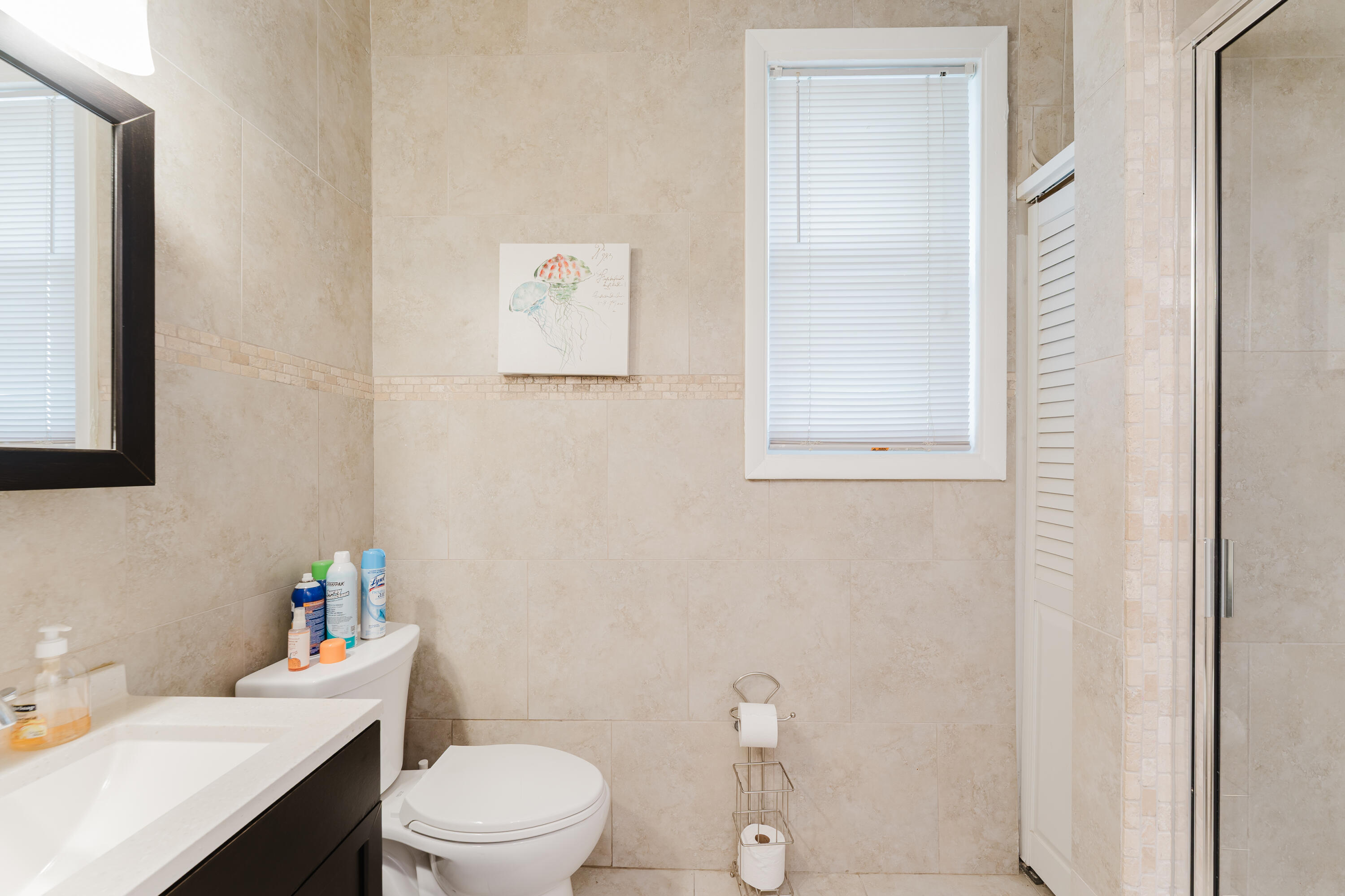 700 East Palmetto Park Road Boca Raton, FL 33432 - Photo 14 of 27 a white toilet sitting next to a bathroom sink