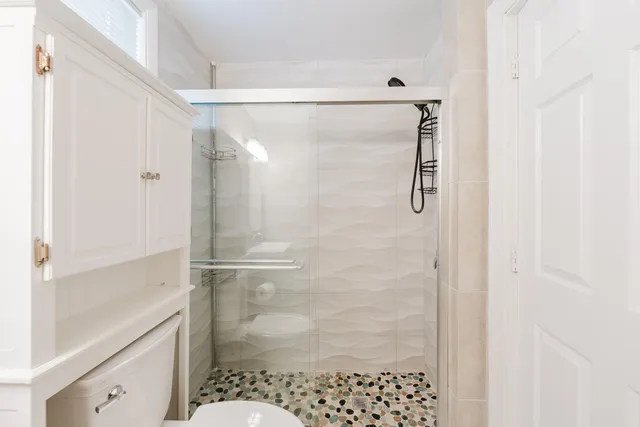 a bathroom with a shower and a sink