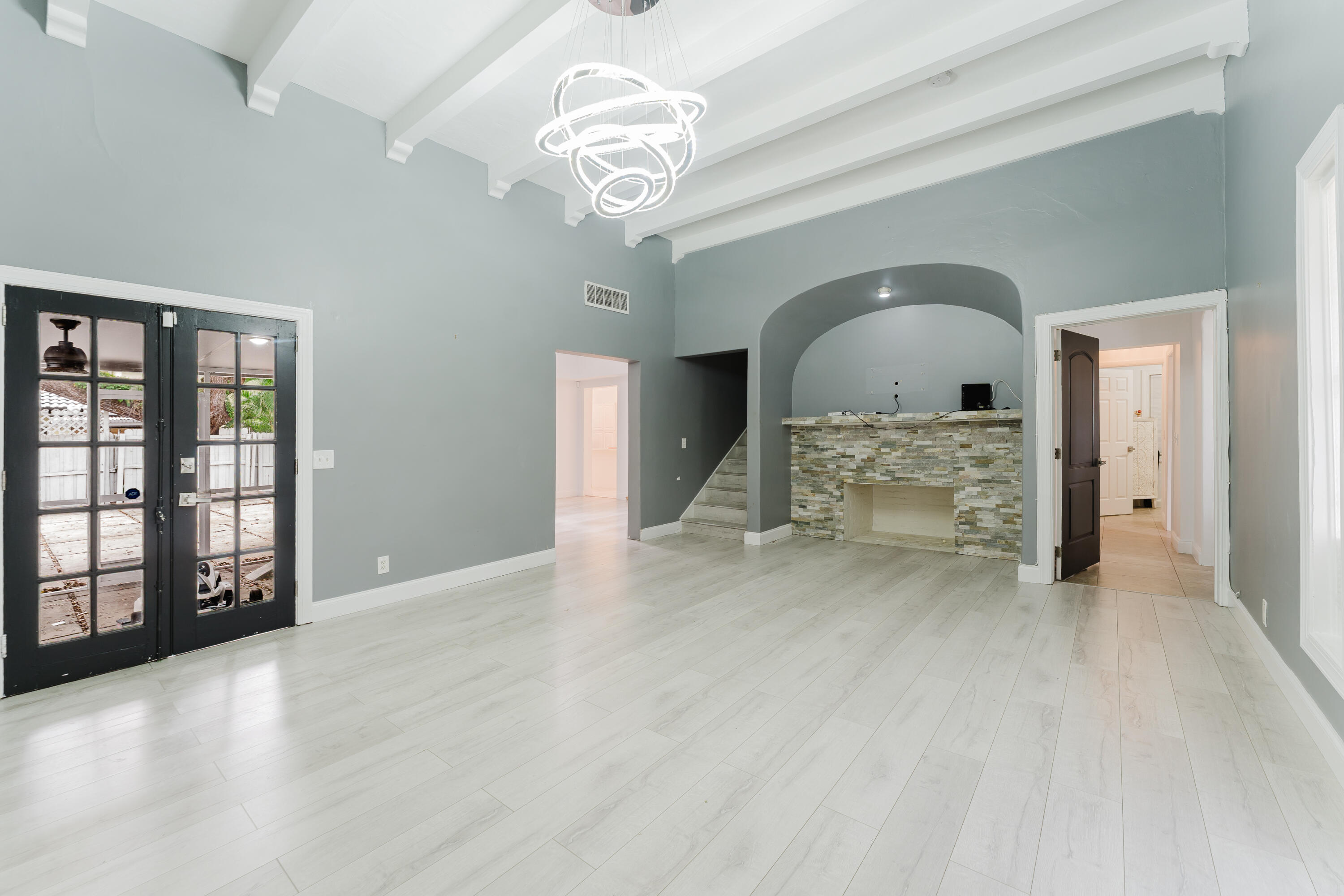 700 East Palmetto Park Road Boca Raton, FL 33432 - Photo 5 of 27 en view of an empty room with a fireplace and chandelier