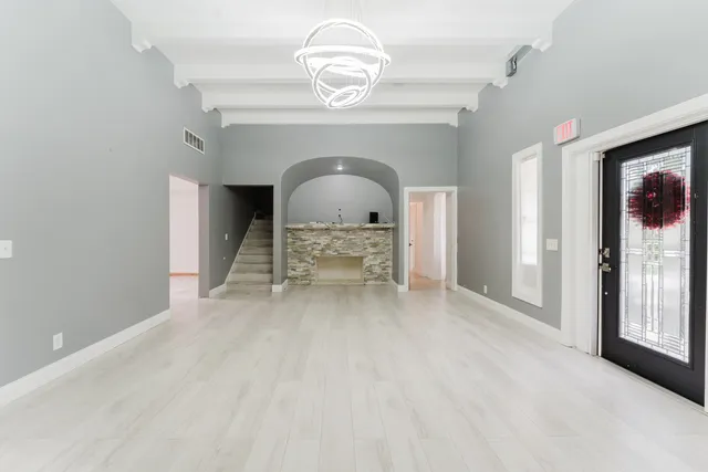 a view of a livingroom with a furniture windows and a chandelier