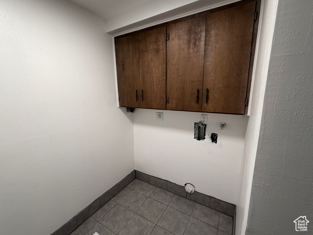 420 North 200 West Logan, UT 84321 - Photo 13 of 13 Laundry area with hookup for a washing machine, cabinet space, and light tile patterned floors