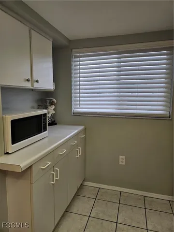 a kitchen with a cabinets and white appliances