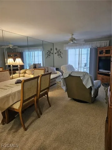 a living room with furniture a window and a flat screen tv