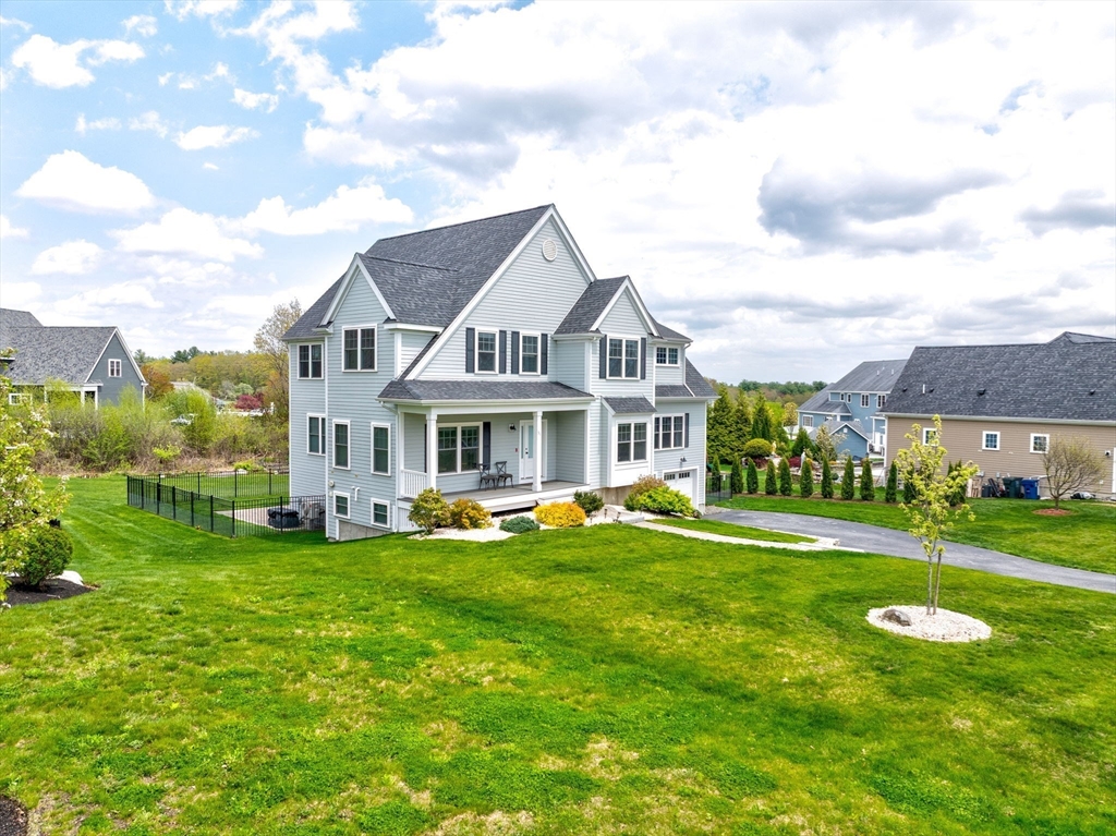 51 Tamarack Road Dracut, MA 01826 - Photo 33 of 39 a front view of a house with a yard table and chairs