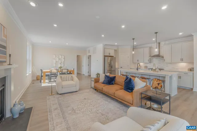 a living room with furniture and kitchen view