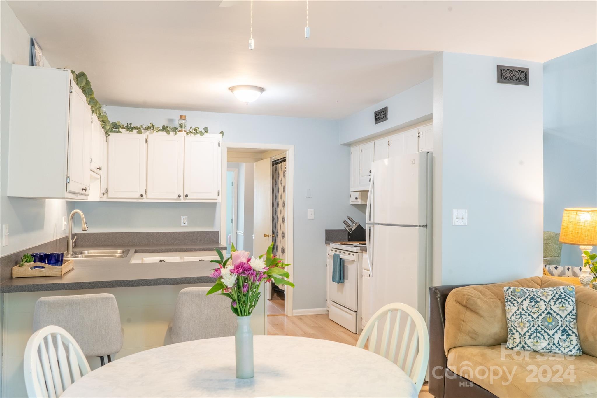 6714 Thermal Road Charlotte, NC 28211 - Photo 6 of 25 a kitchen with a refrigerator and a dining table