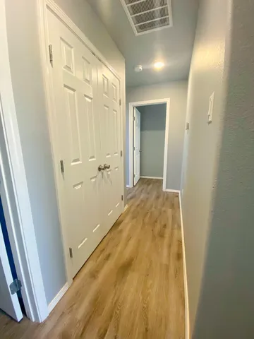 an empty room with kitchen and window