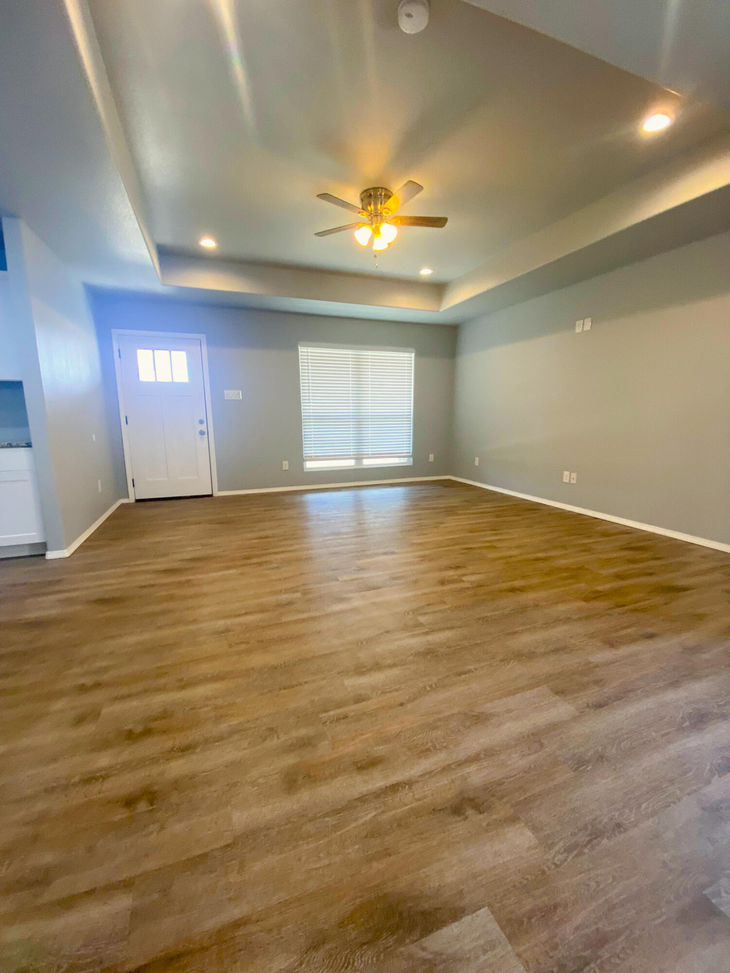 8605 10th Place Lubbock, TX 79416 - Photo 13 of 18 an empty room with kitchen and window
