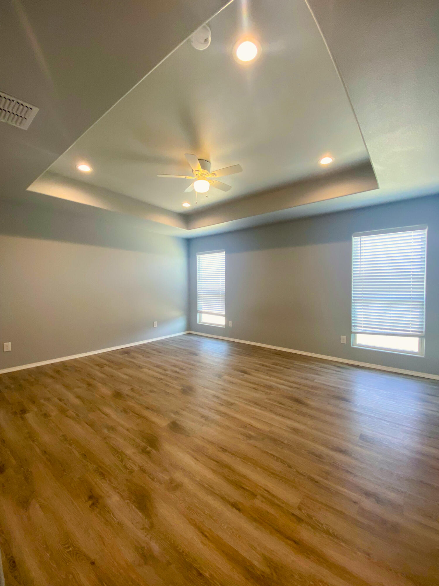 8605 10th Place Lubbock, TX 79416 - Photo 17 of 18 an empty room with wooden floor and windows