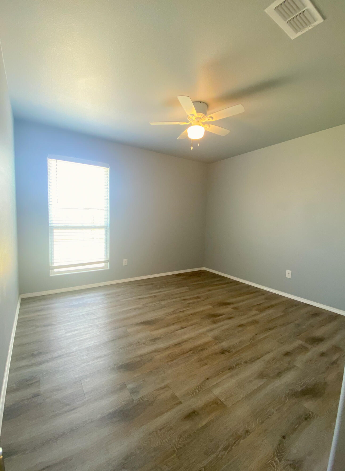 8605 10th Place Lubbock, TX 79416 - Photo 2 of 18 an empty room with wooden floor and windows