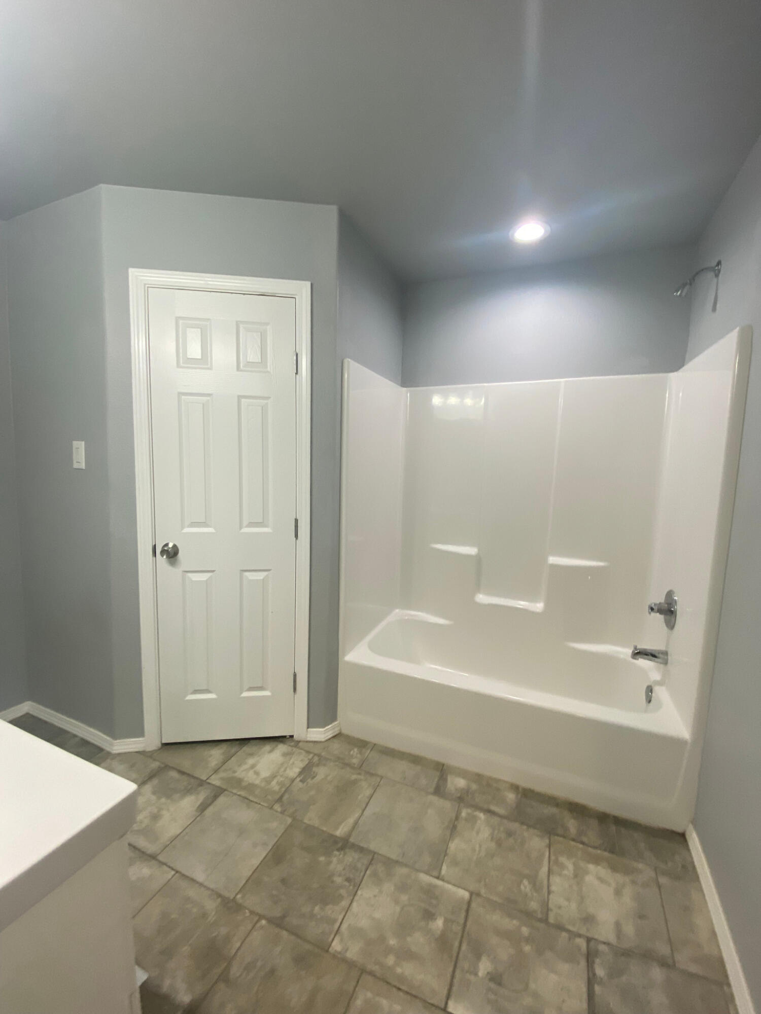 8605 10th Place Lubbock, TX 79416 - Photo 6 of 18 a bathroom with a bathtub and a shower