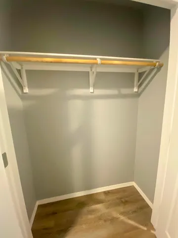 a view of a room with wooden floor