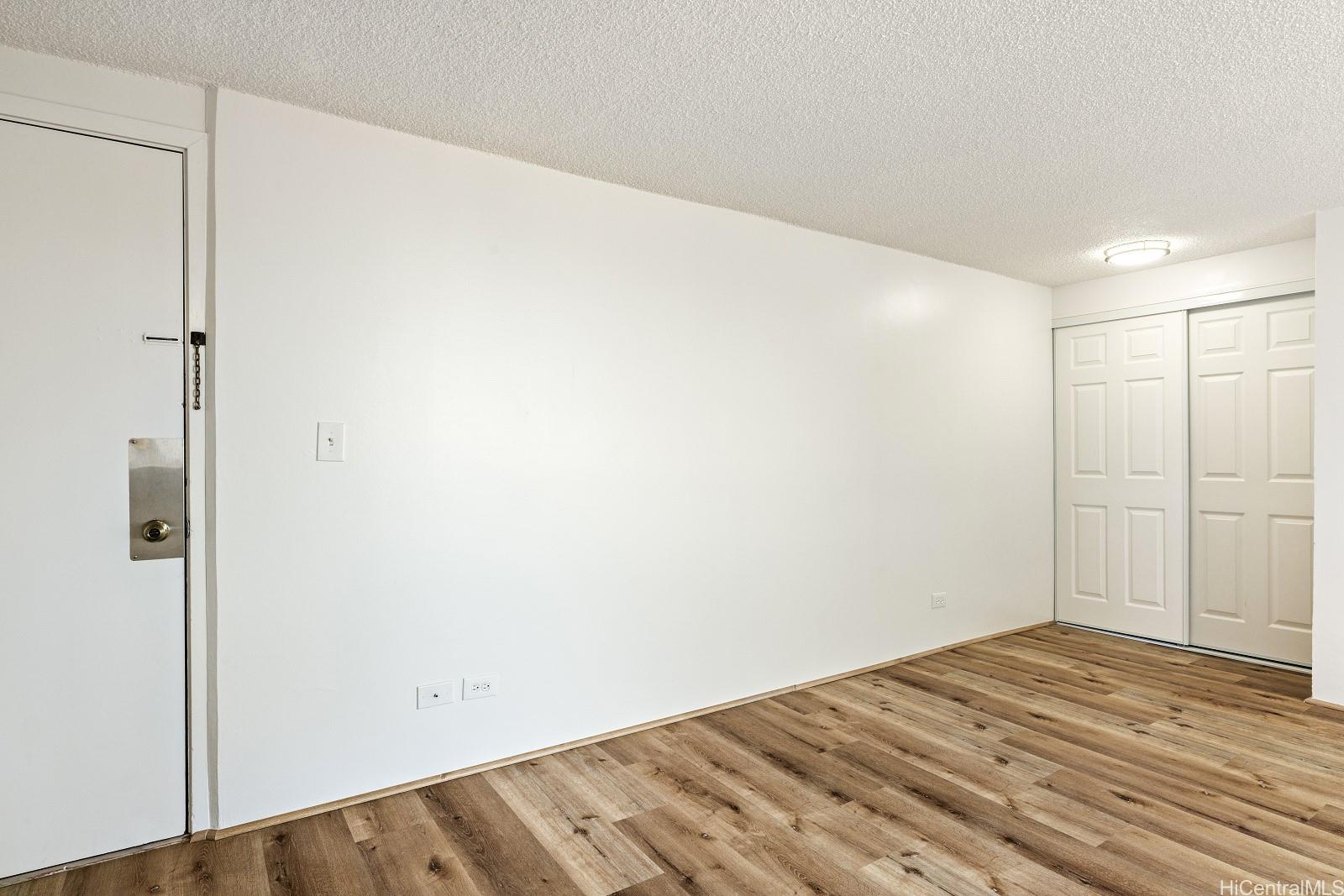 824 Kinau Street, Unit 902 Honolulu, HI 96813 - Photo 12 of 18 a view of a room with wooden floor