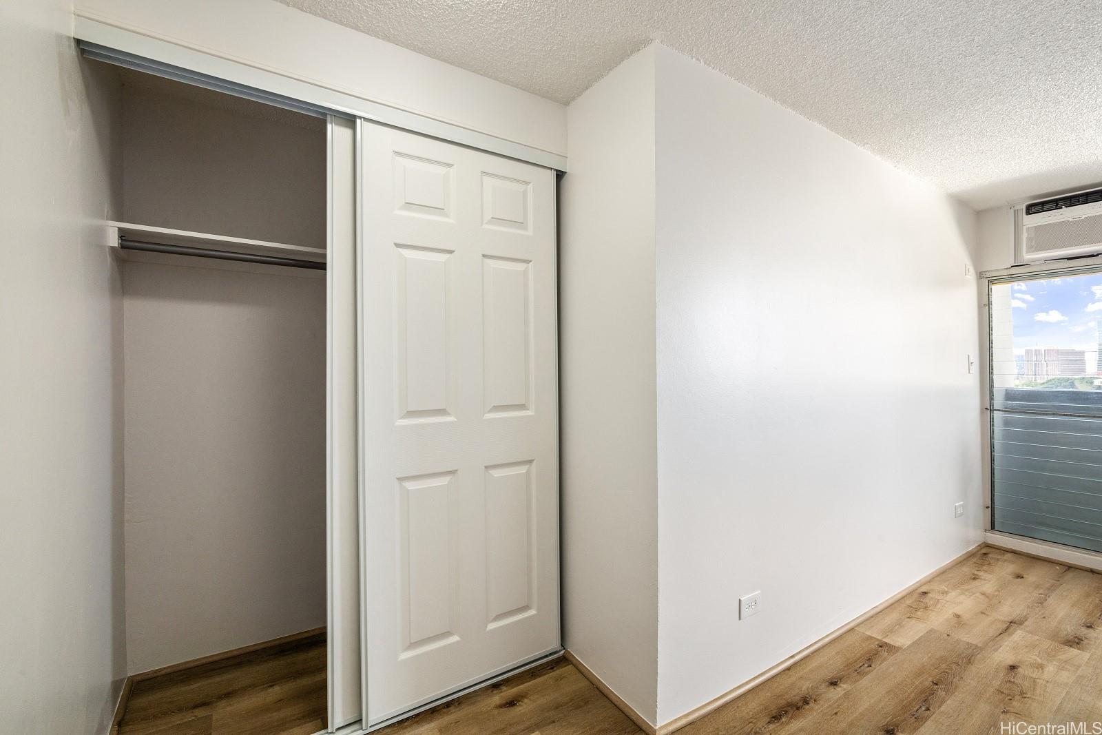824 Kinau Street, Unit 902 Honolulu, HI 96813 - Photo 13 of 18 a view of small space with wooden floor
