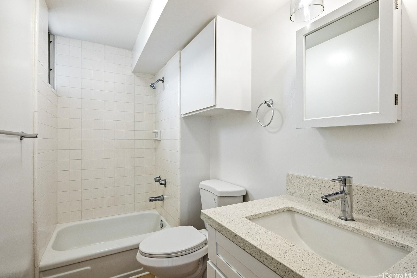 824 Kinau Street, Unit 902 Honolulu, HI 96813 - Photo 14 of 18 a bathroom with a granite countertop sink toilet and shower