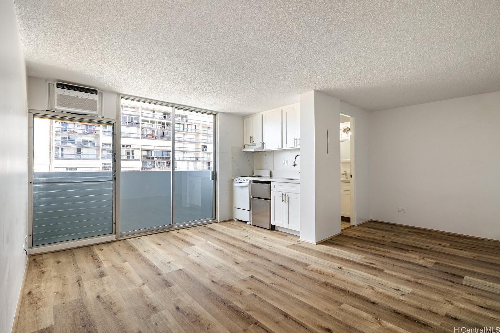 824 Kinau Street, Unit 902 Honolulu, HI 96813 - Photo 3 of 18 a view of a kitchen with wooden floor and a window
