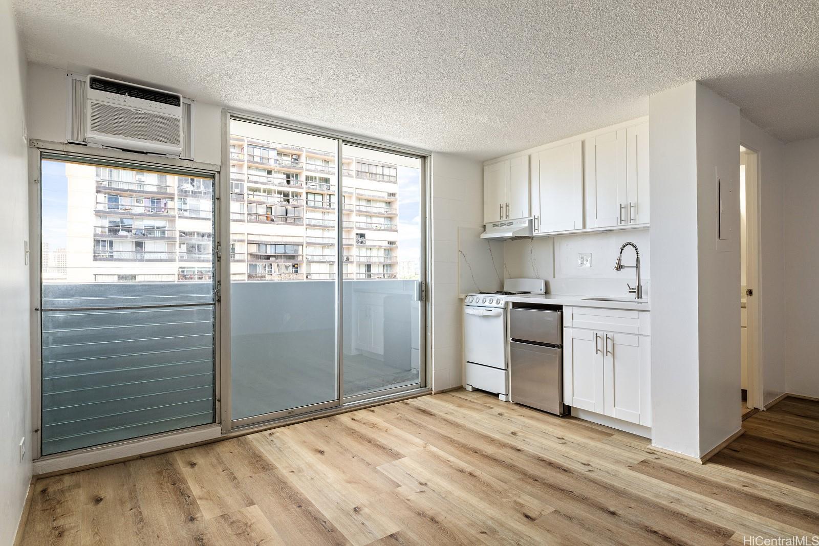 824 Kinau Street, Unit 902 Honolulu, HI 96813 - Photo 4 of 18 a kitchen with stainless steel appliances granite countertop a stove a sink and a refrigerator
