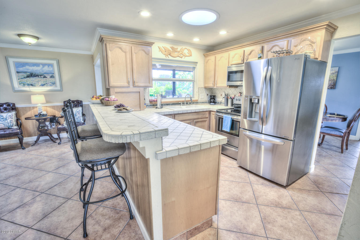 102 Marie Drive Ponce Inlet, FL 32127 - Photo 12 of 32 a kitchen with stainless steel appliances granite countertop a table chairs and a refrigerator