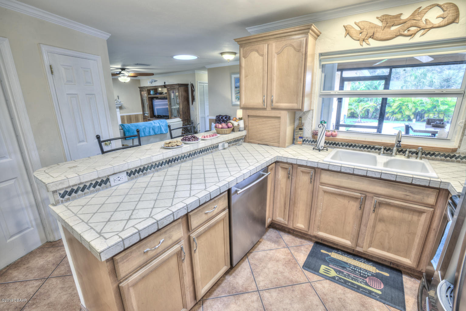 102 Marie Drive Ponce Inlet, FL 32127 - Photo 14 of 32 a large kitchen with kitchen island a large window a sink and counter space