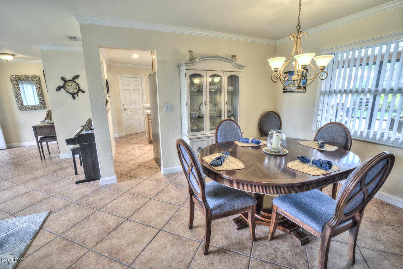 102 Marie Drive Ponce Inlet, FL 32127 - Photo 16 of 32 a view of a dining room with furniture wooden floor and chandelier
