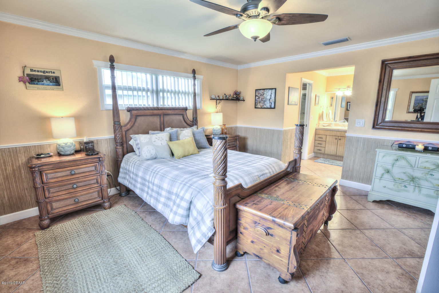102 Marie Drive Ponce Inlet, FL 32127 - Photo 18 of 32 a bed room with a bed and a chandelier