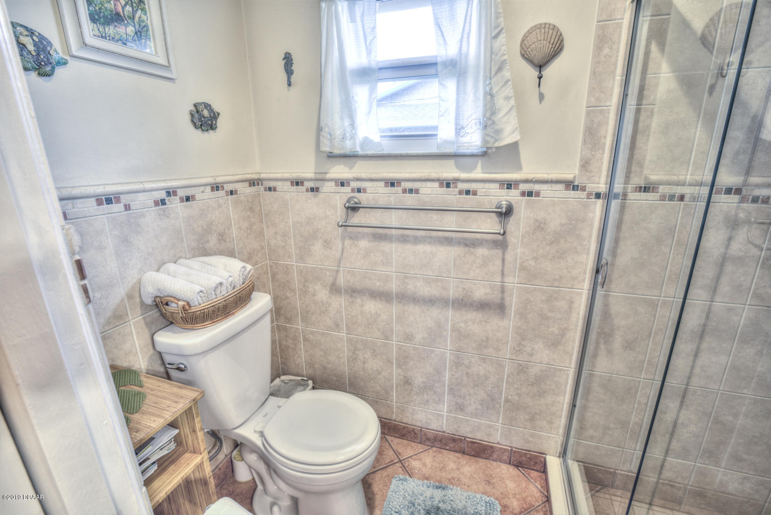 102 Marie Drive Ponce Inlet, FL 32127 - Photo 20 of 32 a white toilet sitting next to a bathroom sink and a shower