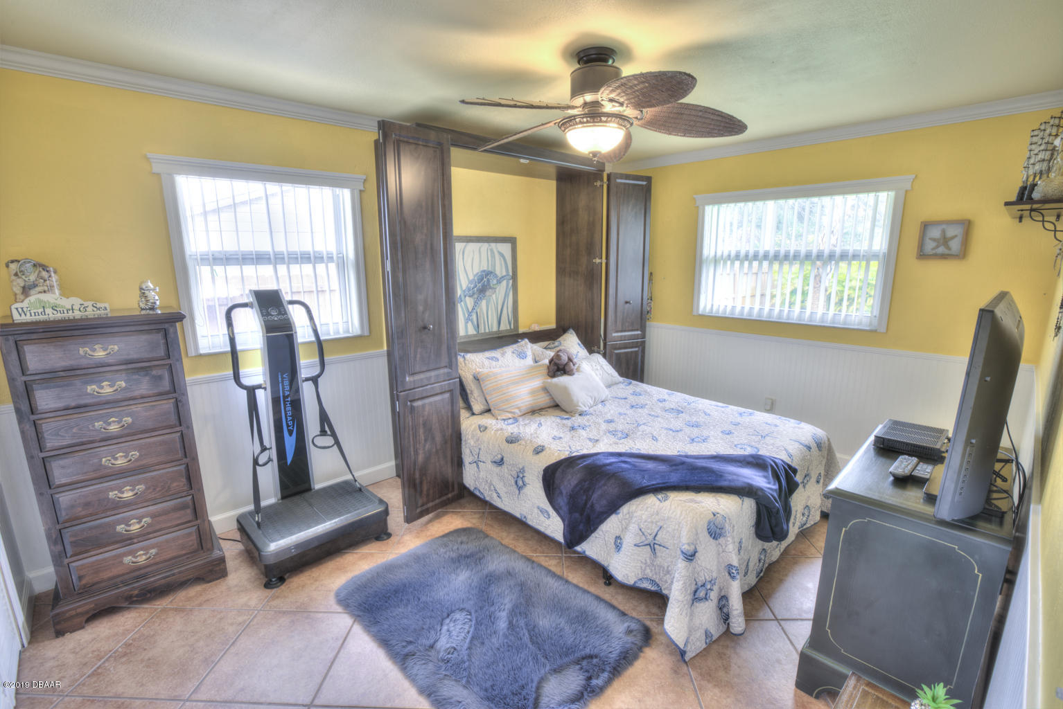 102 Marie Drive Ponce Inlet, FL 32127 - Photo 22 of 32 a bedroom with a bed and wooden floor