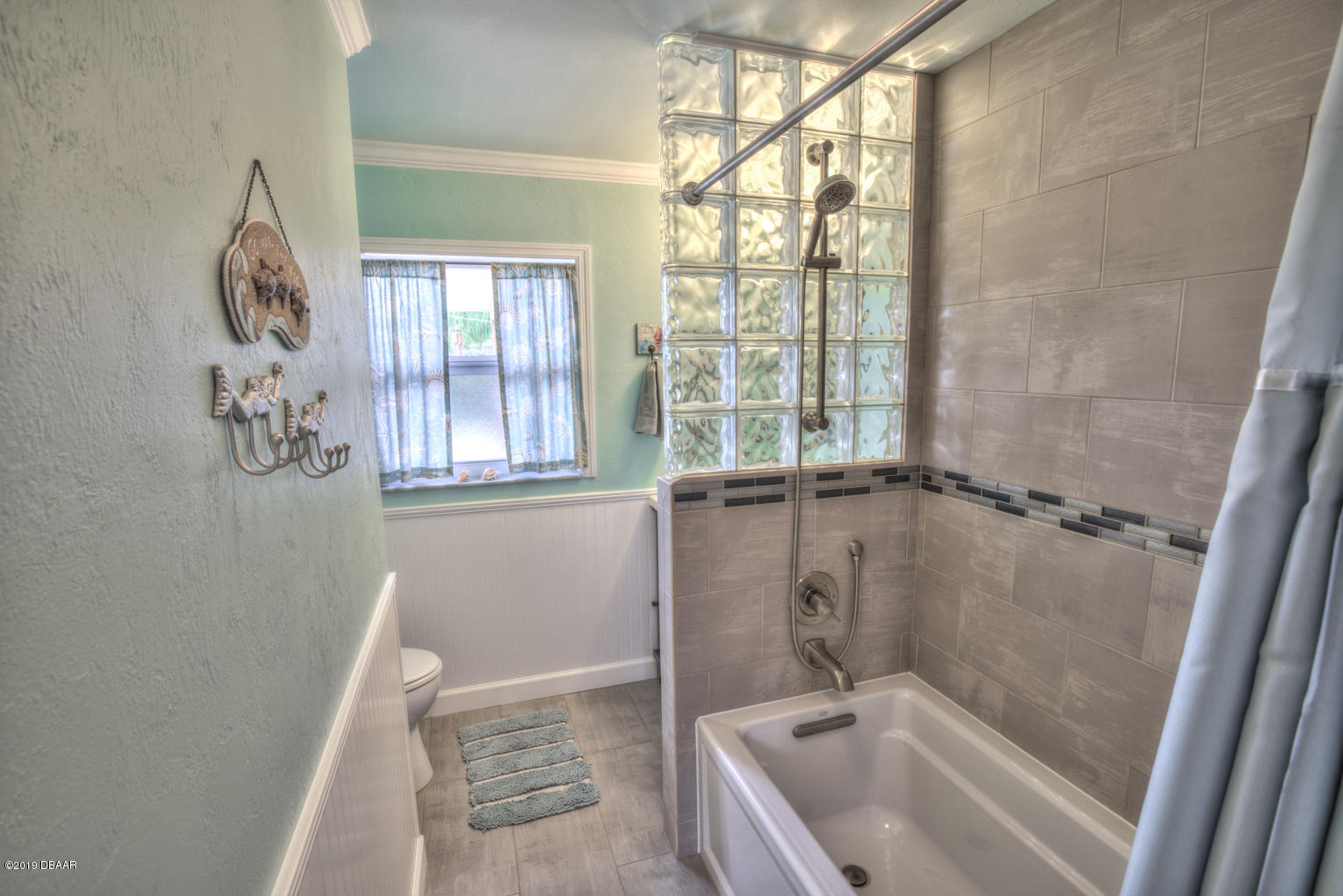 102 Marie Drive Ponce Inlet, FL 32127 - Photo 23 of 32 a bathroom with a granite countertop sink a window and a shower