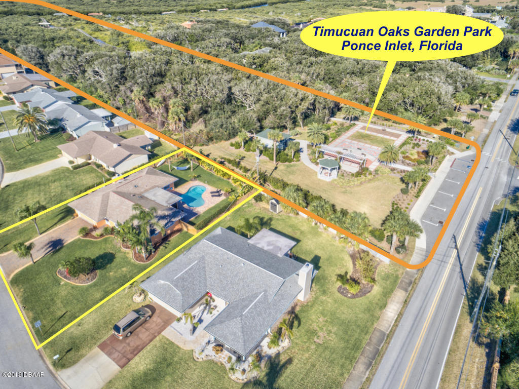 102 Marie Drive Ponce Inlet, FL 32127 - Photo 3 of 32 swimming pool with a garden and plants