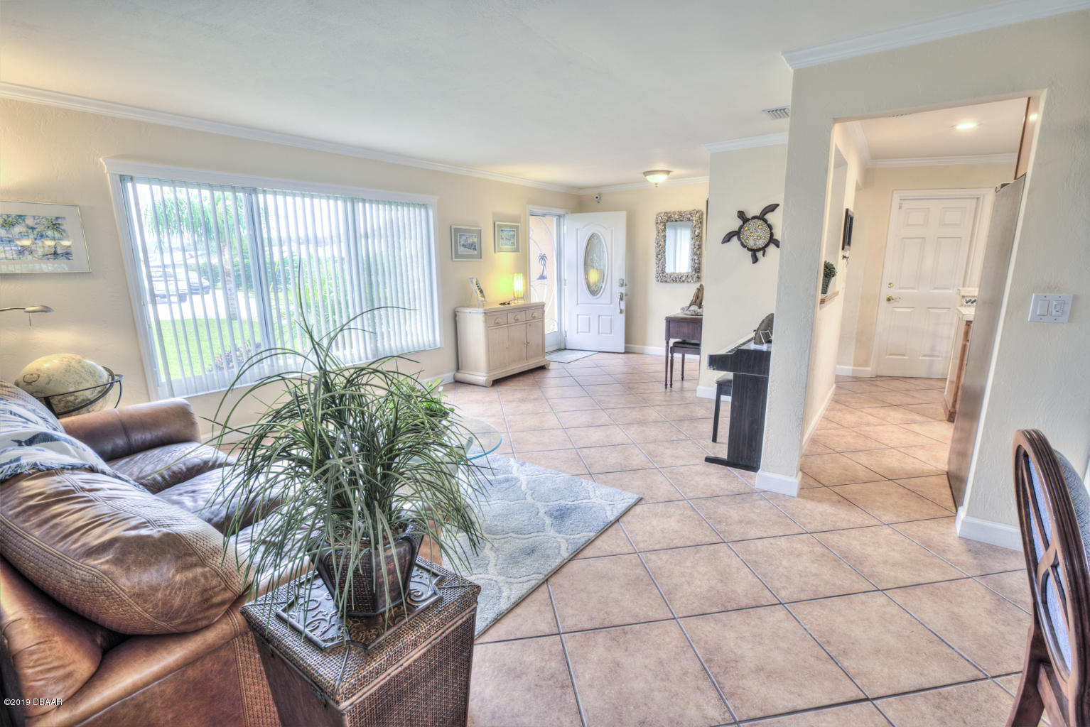 102 Marie Drive Ponce Inlet, FL 32127 - Photo 6 of 32 a living room with furniture and a floor to ceiling window
