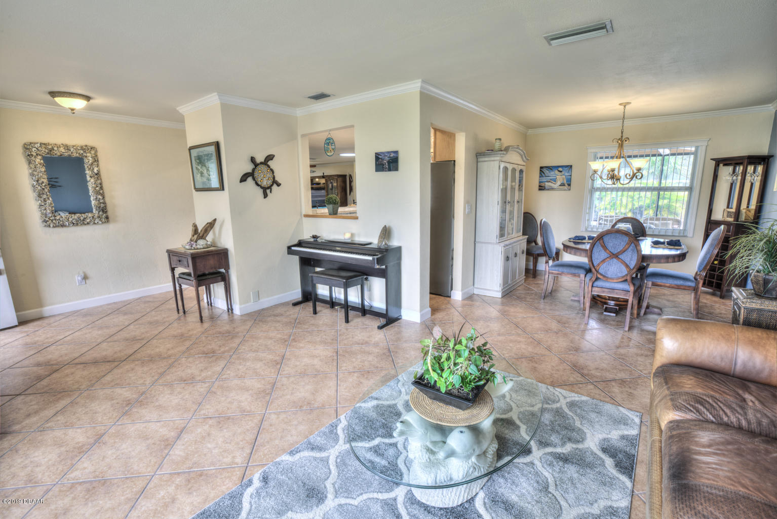 102 Marie Drive Ponce Inlet, FL 32127 - Photo 7 of 32 a living room with furniture and a potted plant